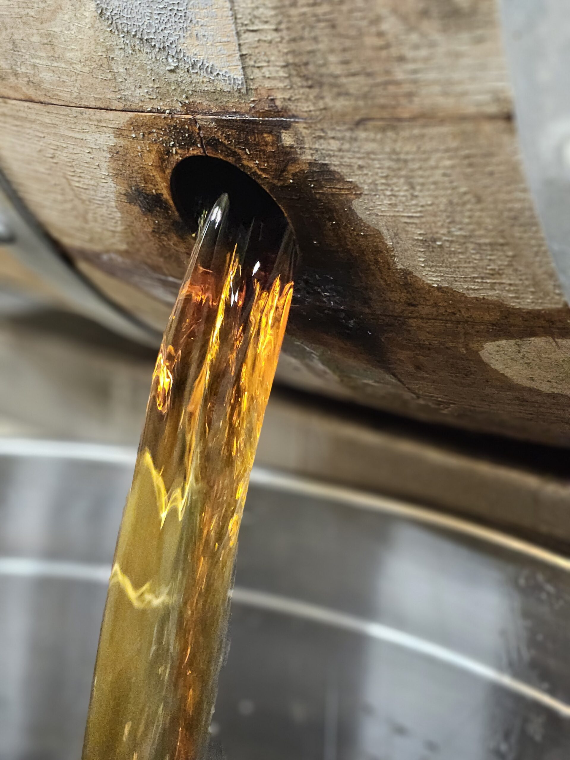 Dumping a whiskey barrel at Bakalian Family Distilling in Brazos County