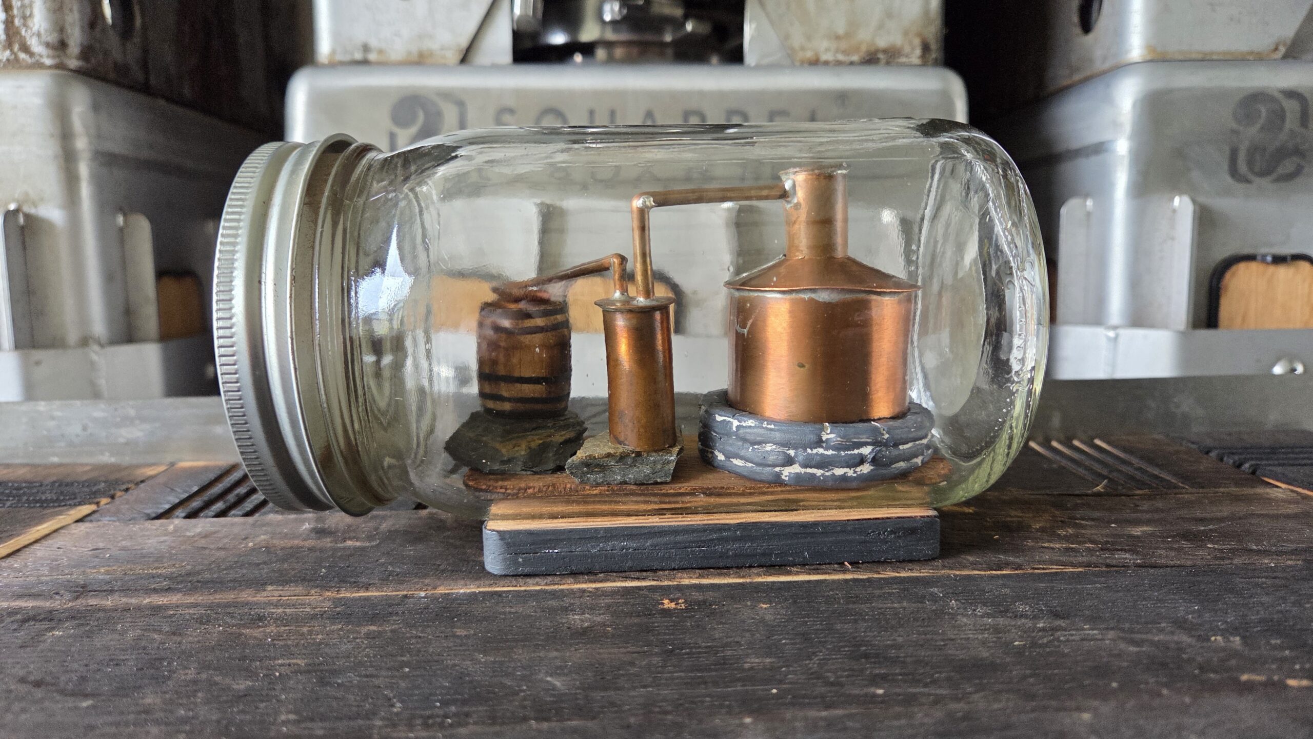 Miniature still and barrels displayed at Bakalian Family Distilling